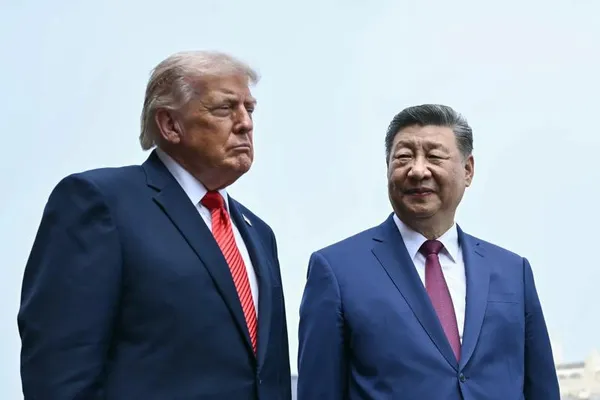 U.S. president Donald Trump and Chinese president Xi Jinping stand against a clear sky in Beijing.
